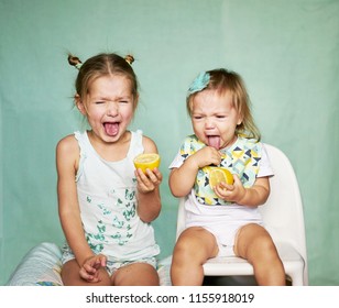Two girls taste sour lemon emotional 