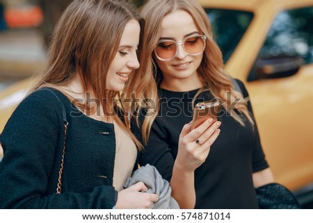 two girls walking city.  shopping and use communications