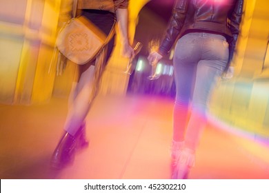 Two Girls Walking Down The City Streets, Ready For A Night Out With Friends