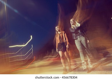 Two Girls Walking Down The City Streets, Ready For A Night Out With Friends