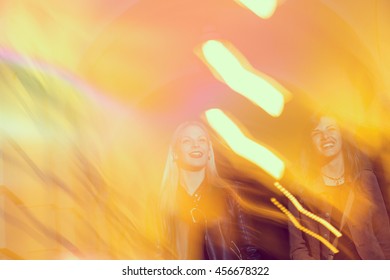 Two Girls Walking Down The City Streets, Ready For A Night Out With Friends