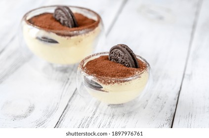 Two Glass Bowls Of Dessert With Oreo Cookies And Cream Cheese