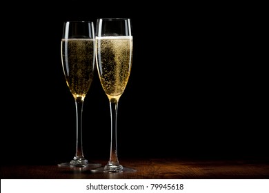 two glass with champagne on a wooden table
