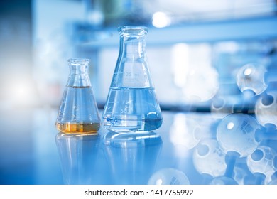 two glass flask in chemical science education laboratory with molecular structure in blue background