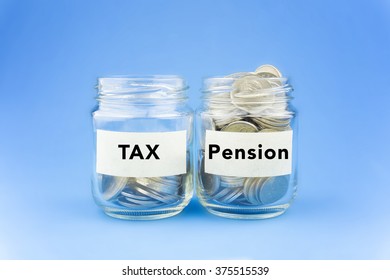 Two Glass Jars With Coins Labeled Pension And TAX On Blue Background. Financial Conceptual