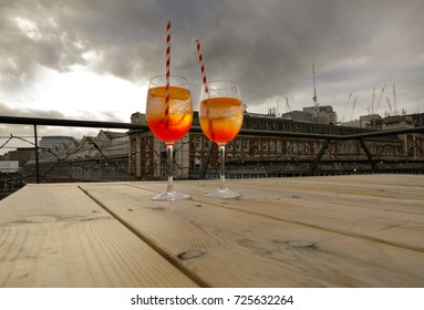 Two Glasses Of Aperol Spritz On A Table At A Rooftop  Bar In London