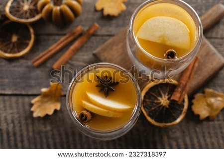 Two glasses with apple cidr on wooden table background. Winter hot Beverage. Top view.