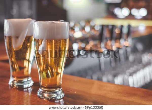 Two Glasses Beer On Bar Table Stock Photo (Edit Now) 596133350