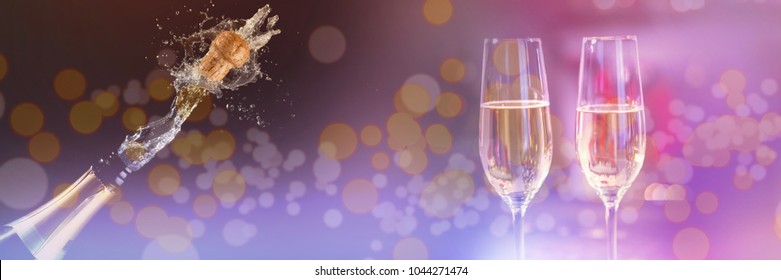 Two Glasses Of Champagne Against Champagne Cork Popping