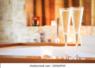 Two glasses of champagne with candle near jacuzzi. Valentines background. Romance concept. Horizontal