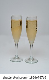 Two Glasses Of Champagne Isolated On White Fizz