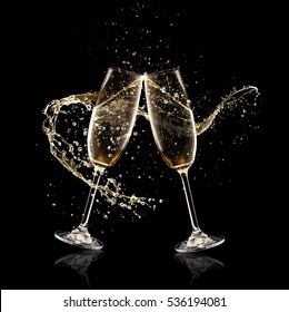 Two glasses of champagne with splash over black background. Celebration concept, free space for text