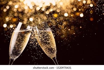 Два бокала шампанского, тосты ночью с огнями боке, блестками и искрами на заднем плане