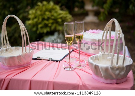 Two glasses of champagne at the wedding ceremony. Wedding ceremony. Beautiful table decorations for wedding ceremony