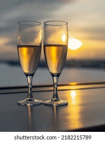 Two Glasses With Champagne At Window On Sunset