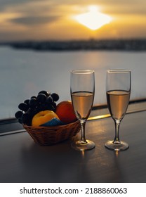 Two Glasses With Champagne At Window On Sunset