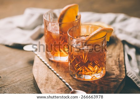 Two glasses of cocktail with orange slice. Toned image