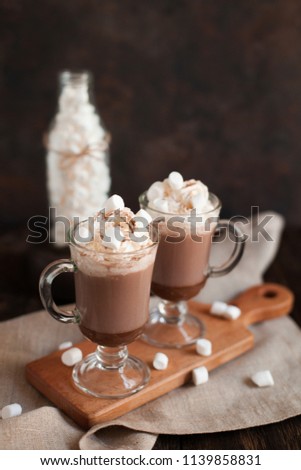 Two glasses with Cocoa, coffee with marshmallows and homemade cookies on dark wooden background with Cozy plaid from merinose wool. Winter, New Year, Christmas still life.