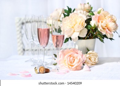 Two Glasses Filled With Pink Champagne With Flowers