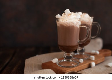 Two glasses with Hot chocolate garnished with whipped cream, marsmallow and cocoa powder. Winter and autumn time. Christmas drink - Powered by Shutterstock