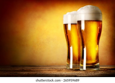 Two glasses of lager on a wooden table - Powered by Shutterstock