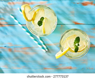 two glasses of lemonade shot from overhead view on rustic table top