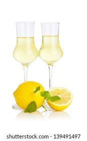 Two Glasses Of Limoncello Liquor With Lemons Isolated On White Background