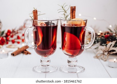 Two glasses of mulled wine on the table surrounded by New Year's lights. Festive mood