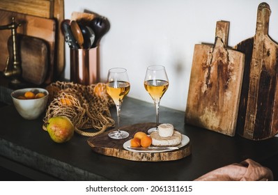 Two Glasses Of Orange Or Amber Wine And Appetizers