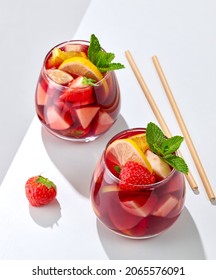 two glasses of red sangria on white restaurant table