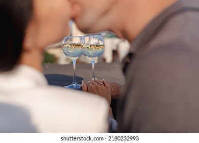 Two Glasses Of Red Or White Wine Close-up In Hands Outside The House. Man And Woman In Love Make The Clink Of Glasses. Celebrate Valentine's Day, Date. Warm, Blurred Background, Countryside Relaxation