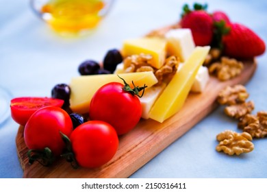 Two Glasses Of Red Wine And Cheese Plate On The Table At The Balcony. Fine Dining At Home.