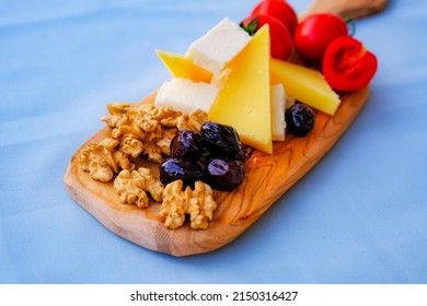 Two Glasses Of Red Wine And Cheese Plate On The Table At The Balcony. Fine Dining At Home.