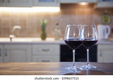 Two Glasses Of Red Wine On  Kitchen Table