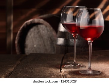 Two glasses of red wine on a table in a vintage beer cellar