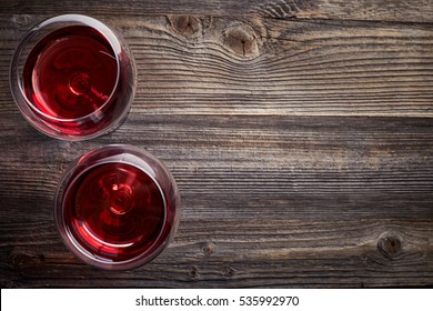 Two Glasses Of Red Wine On Dark Wooden Background From Top View