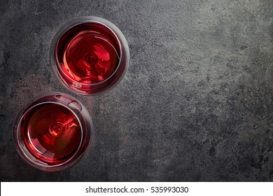 Two Glasses Of Red Wine On Dark Gray Background From Top View