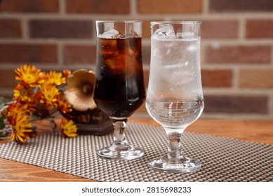 Two glasses of refreshing cola and sprite with ice, perfect for a cool drink.