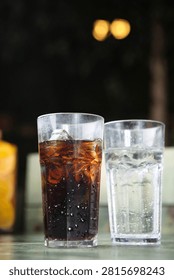 Two glasses of refreshing cola and sprite with ice, perfect for a cool drink.