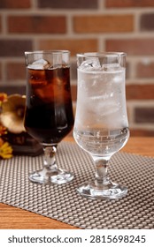Two glasses of refreshing cola and sprite with ice, perfect for a cool drink.
