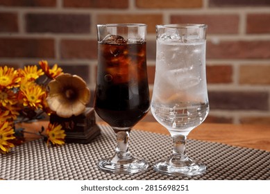Two glasses of refreshing cola and sprite with ice, perfect for a cool drink.