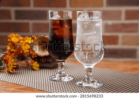 Two glasses of refreshing cola and sprite with ice, perfect for a cool drink.