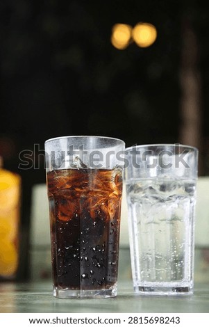 Two glasses of refreshing cola and sprite with ice, perfect for a cool drink.