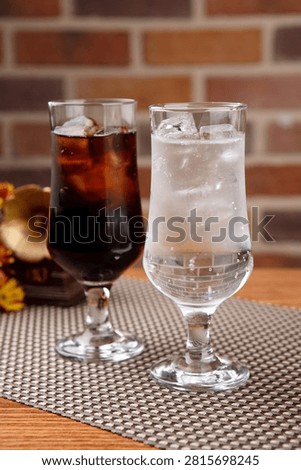 Two glasses of refreshing cola and sprite with ice, perfect for a cool drink.
