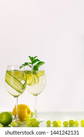 Two Glasses Of Spritzer Or Lemonade With Lime, Cucumber, Lemon And Mint.