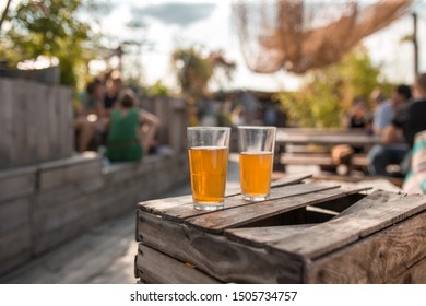 Two glasses of tea on broken wooden table at dachgarten in Munich