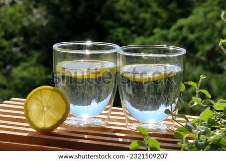 Two glasses of water and lemon