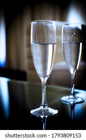 Two Glasses Of Water On A Glass Table. No People