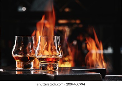 Two Glasses Of Whiskey On A Fire Background