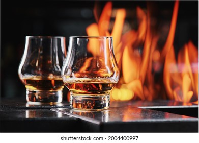 Two Glasses Of Whiskey On A Fire Background